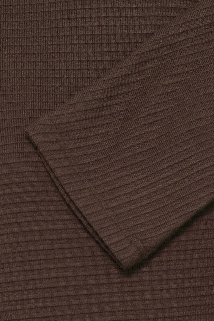 Close-up of a dark brown ribbed knit fabric, showing the texture and folded cuff detail.