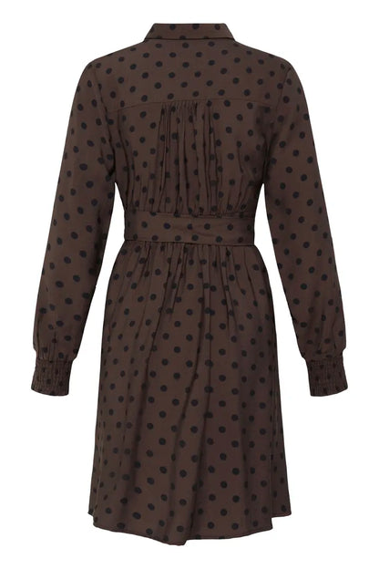 A dark brown long-sleeve shirt dress with black polka dots, shown from the back against a plain white background.