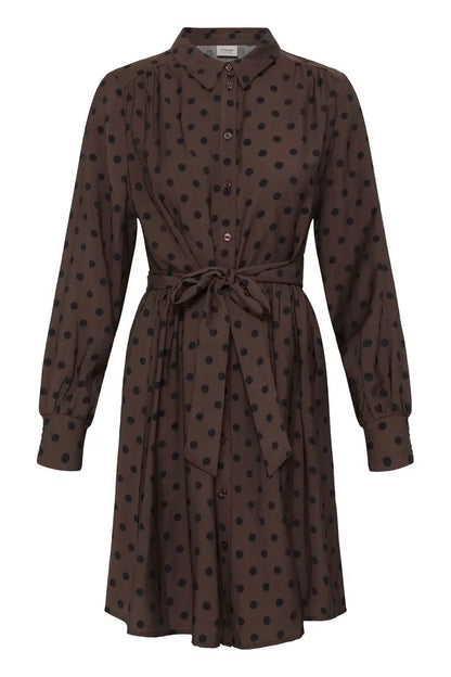A dark brown long-sleeve shirt dress with a black polka dot pattern, featuring a pointed collar, button-down front, and a matching fabric tie belt at the waist.