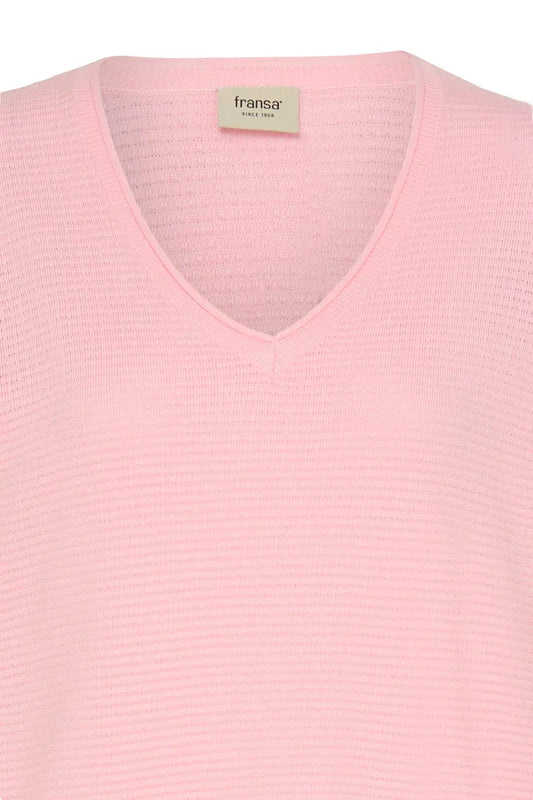 A close-up of a light pink ribbed knit sweater with a V-neck collar, featuring a visible 'fransa' brand label inside the neckline.