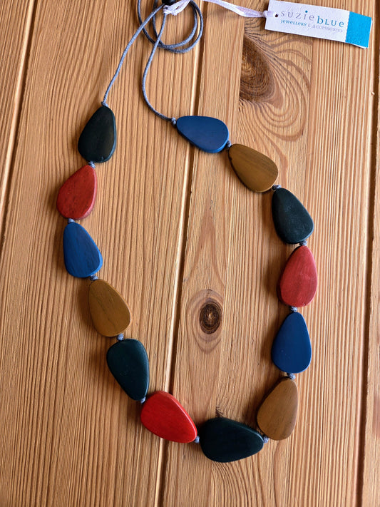 Colorful necklace with teardrop shaped beads on a wooden surface