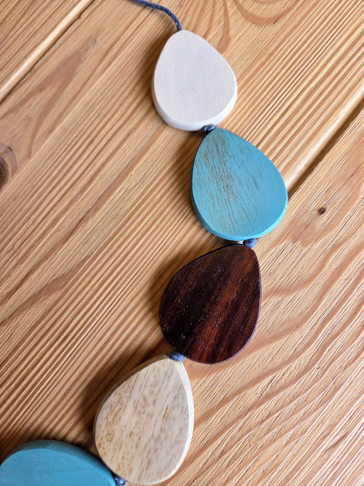 Colorful wooden bead necklace on a wooden surface