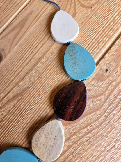 Colorful wooden bead necklace on a wooden surface